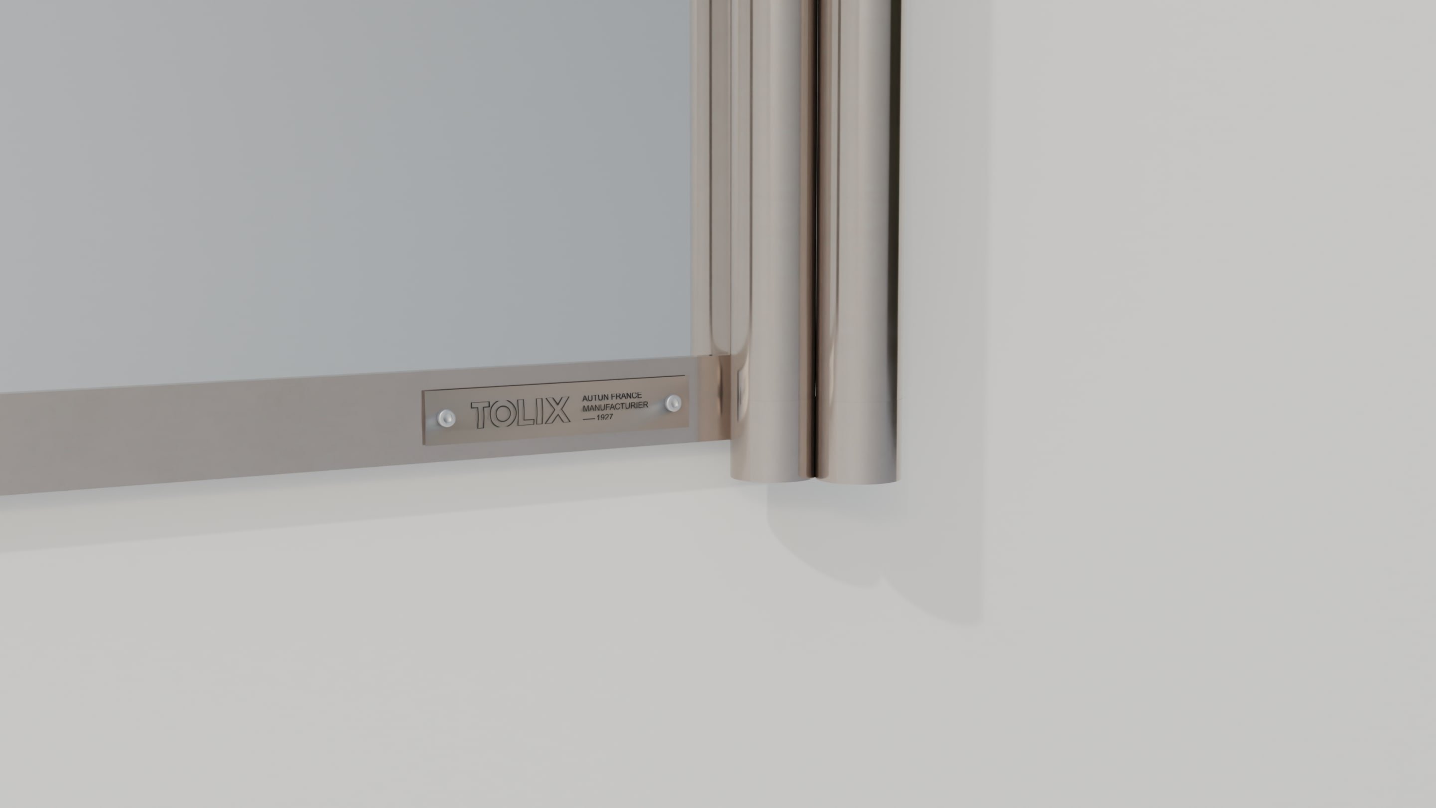 Détail du cadre en tube chromé et de la plaque TOLIX rivetée sur le miroir